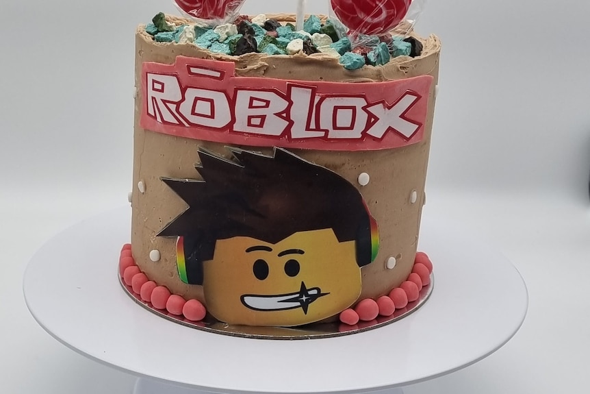 Roblox character face full cake served on a white plate