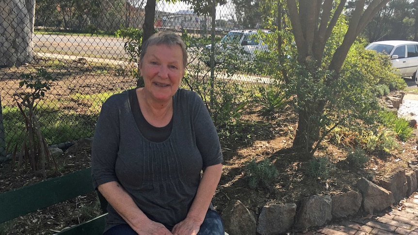 Bairnsdale woman Sue Braggs sits on park bench.