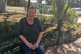 Bairnsdale woman Sue Braggs sits on park bench.