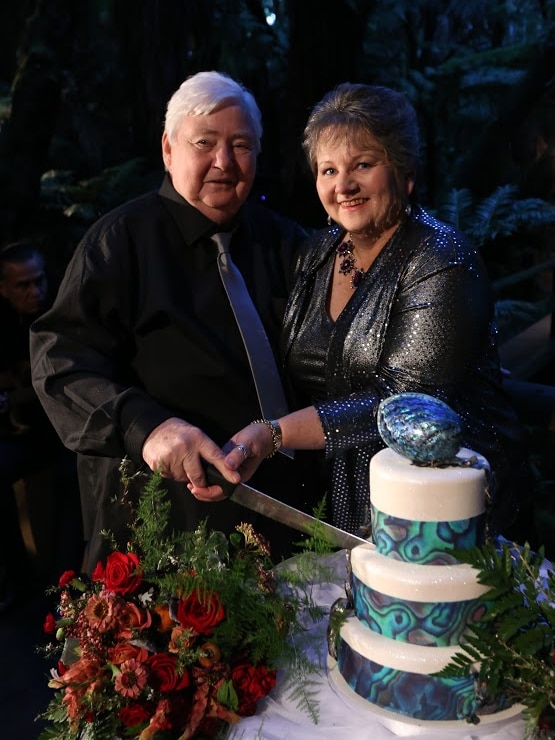 Lee Bransden and Sandra Yates cut their wedding cake after the ceremony in the Maori cultural village.