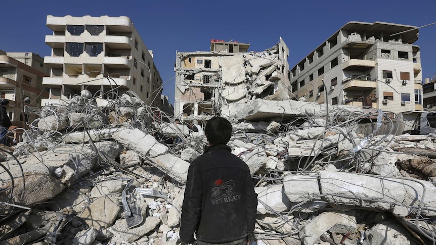 A man inspects a site that was hit by an Israeli strike, killing a Lebanese militant leader Samir Qantar.