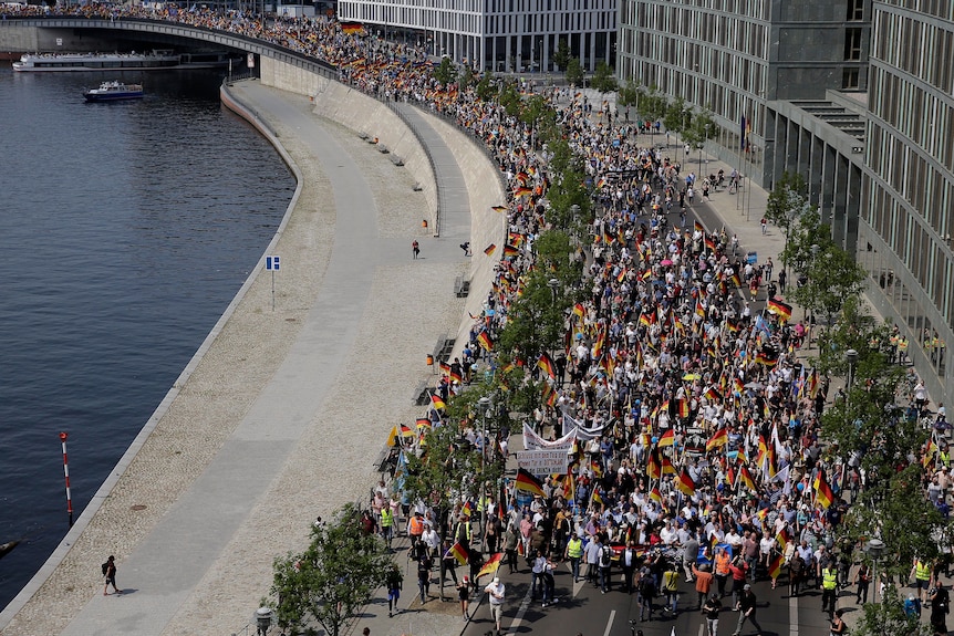 Aerial view of AfD supporters marching near the river in Berlin.