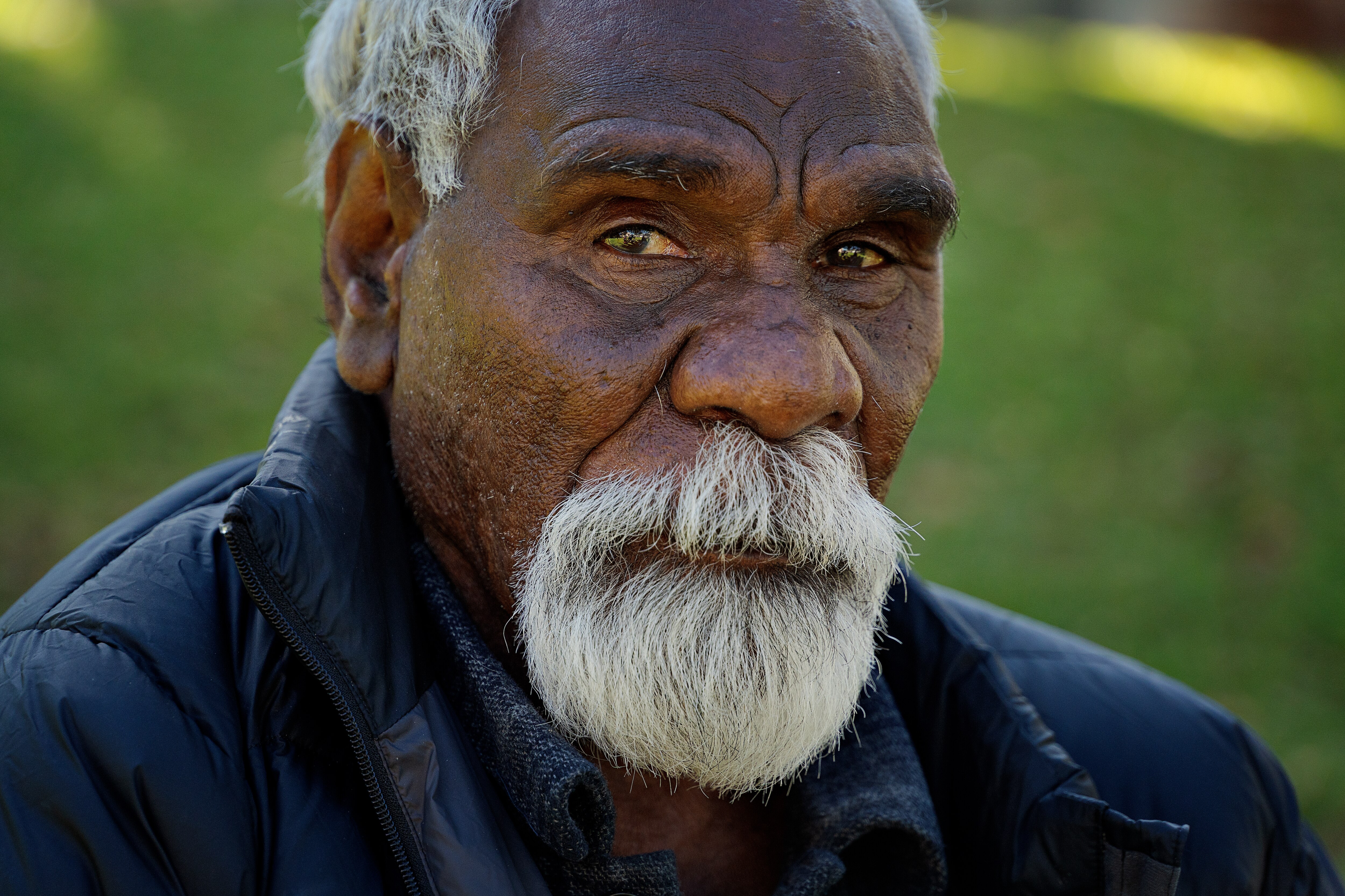 A close-up of an Indigenous man, who has facial hair.