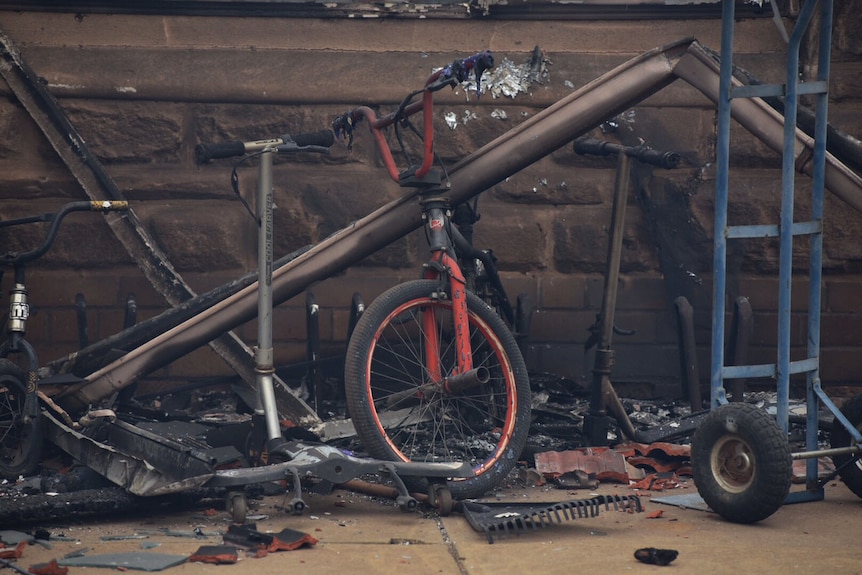 Fire-damaged items in the yard of a house