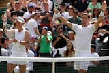 Sam Stosur and Matt Ebden hold their arms up and applaud the crowd after a win