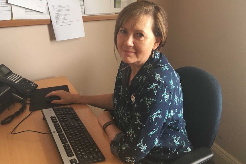 Limestone Coast Migrant Resource Centre manager Anelia Blackie sits at her desk.