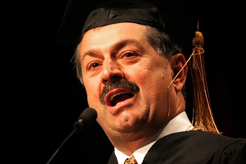 Andrew Liveris dressed in an academic cap and gown