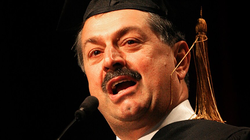 Andrew Liveris dressed in an academic cap and gown