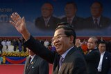 Cambodian prime minister Hun Sen greets supporters in Phnom Penh on January 7, 20