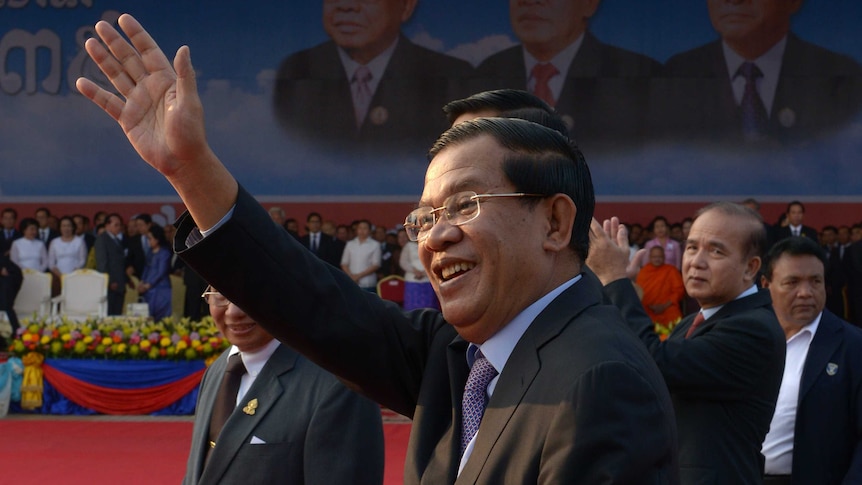 Cambodian prime minister Hun Sen greets supporters in Phnom Penh on January 7, 20