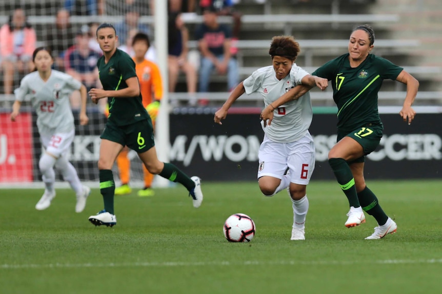 Kyah Simon and Saori Aryoshi battle for the ball