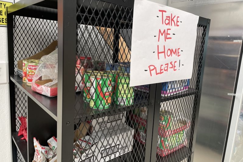 Free cans of food with a sign that says 'please take me home'