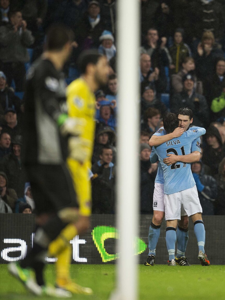 Late but great ... Manchester City's Gareth Barry (R) celebrates his injury-time winner over Reading.