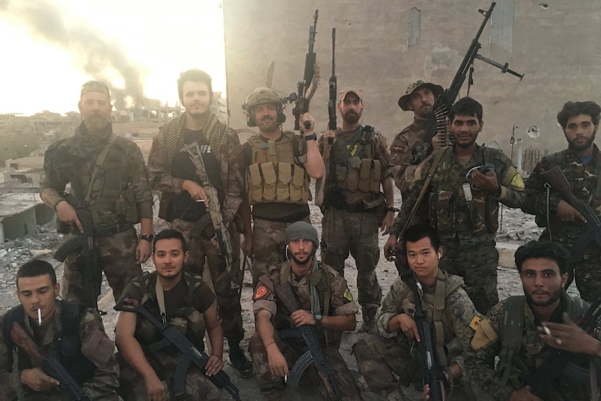 Jamie Williams (seated, centre) was among a small group of foreigners who joined the US backed Kurdish militia, the YPG.