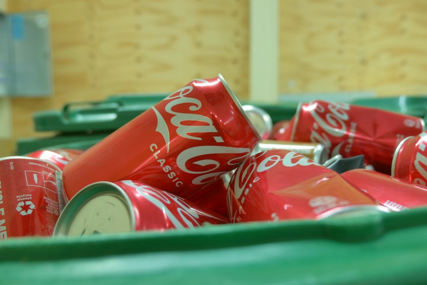 A box full of empty coke cans