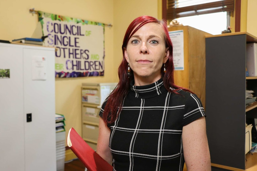 Jenny Davidson stands in an office.