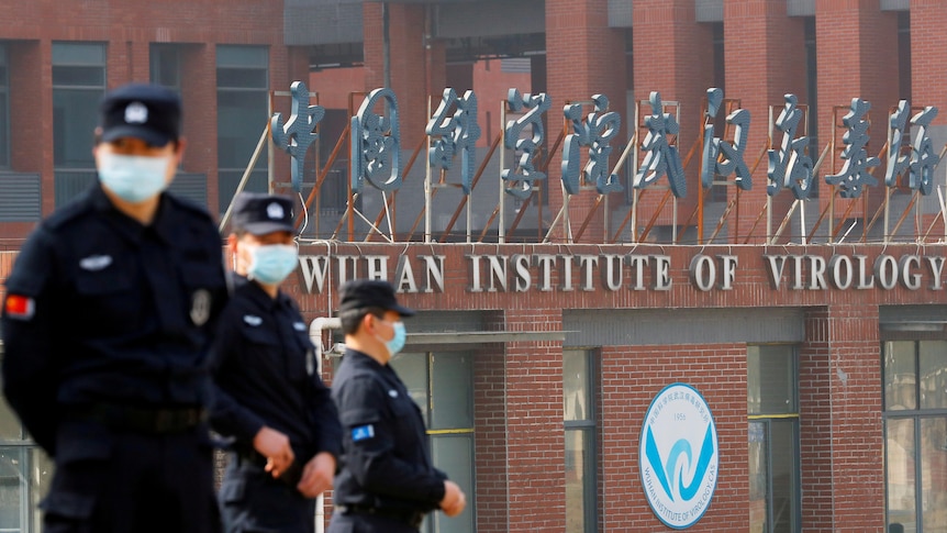 Security personnel keep watch outside the Wuhan Institute of Virology during the visit by the World Health Organisation.