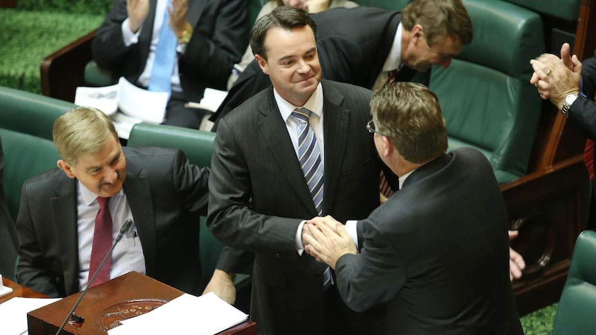 Victorian Treasurer Michael O'Brien (centre) shakes Premier Denis Napthine's hand