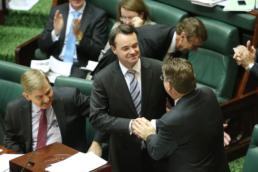 Victorian Treasurer Michael O'Brien (centre) shakes Premier Denis Napthine's hand