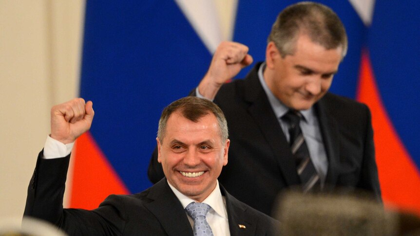 Crimean PM Sergei Aksyonov (right) and parliamentary speaker Vladimir Konstantinov (left) celebrate at the Kremlin.