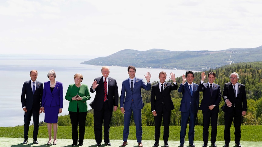 G7 leaders pose for family photo.