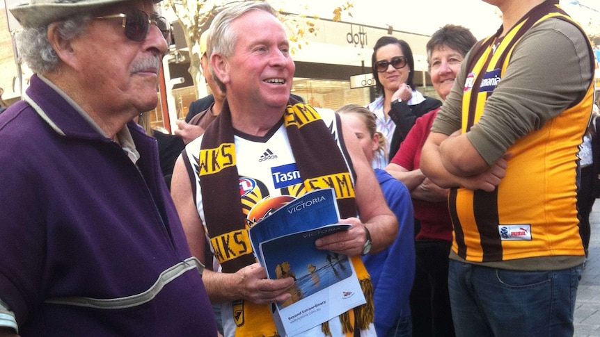 WA Premier Colin Barnett in Hay Street Mall with Hawks guernsey and scarf on