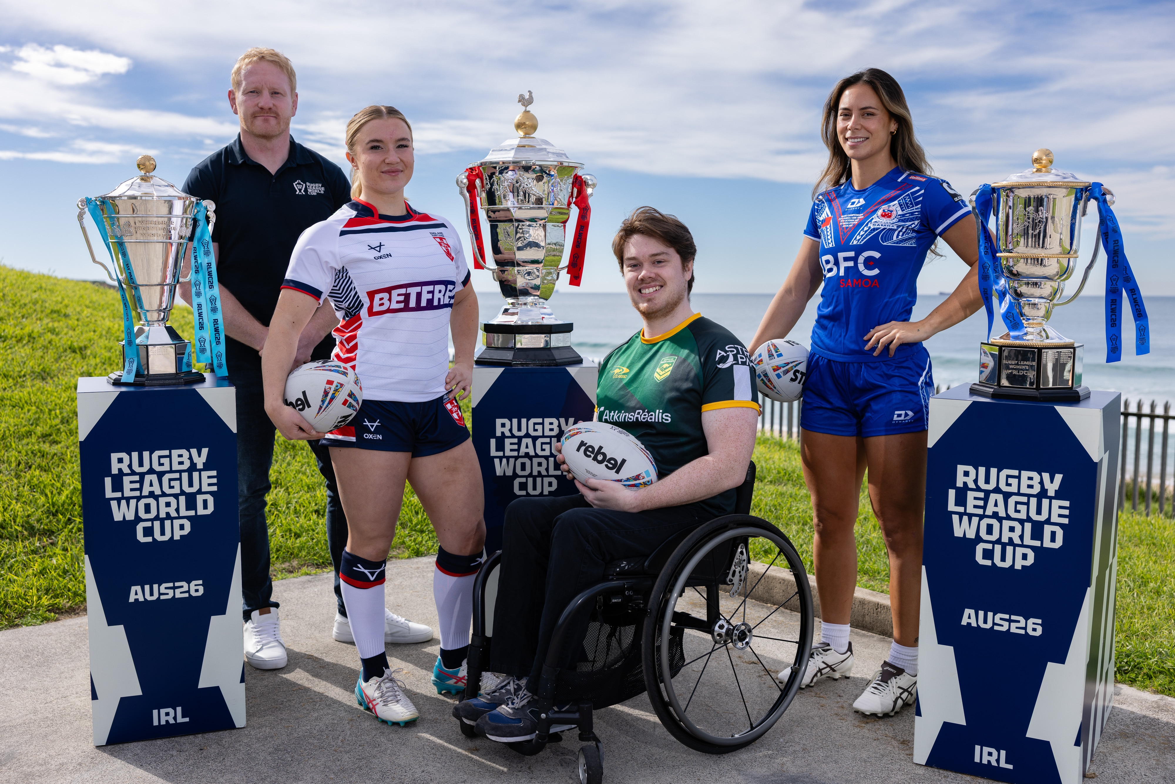 Liam Luff standing with men's and women's RLWC stars