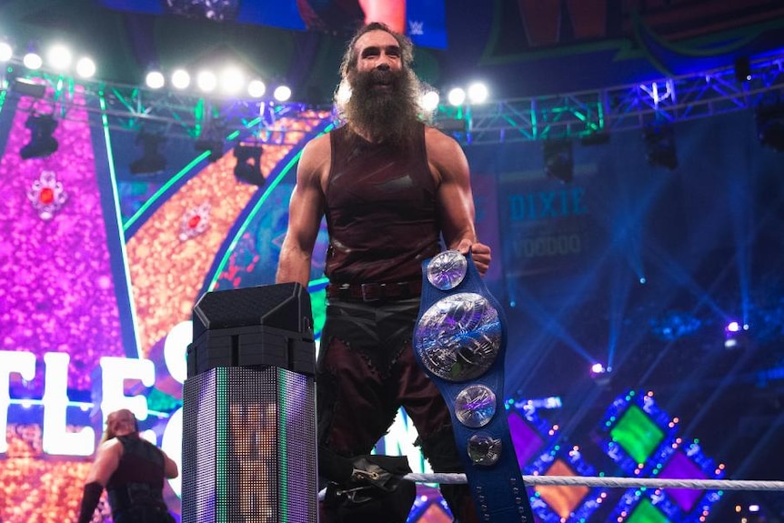 Jon Huber, wrestling under the name Luke Harper in WWE, celebrating after winning the WWE Smackdown Tag Team Championship