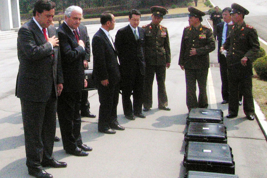 Bill Richardson and Anthony Principi with US soldiers remains in North Korea