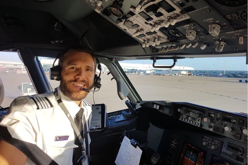Daniel Lang sits in the cockpit of a plane