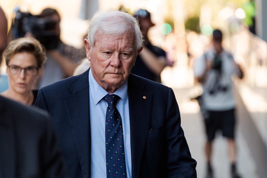 Ciara Glennon's father Denis walks in front of a Perth court. He looks very grave.