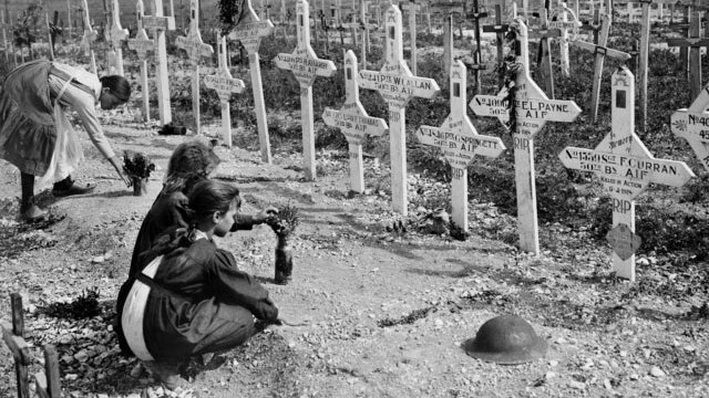 French children tend to graves of Australians killed in battle.