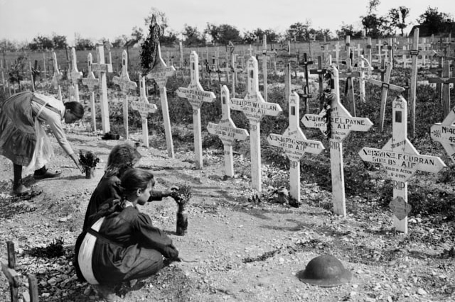 French children tend to graves of Australians killed in battle.