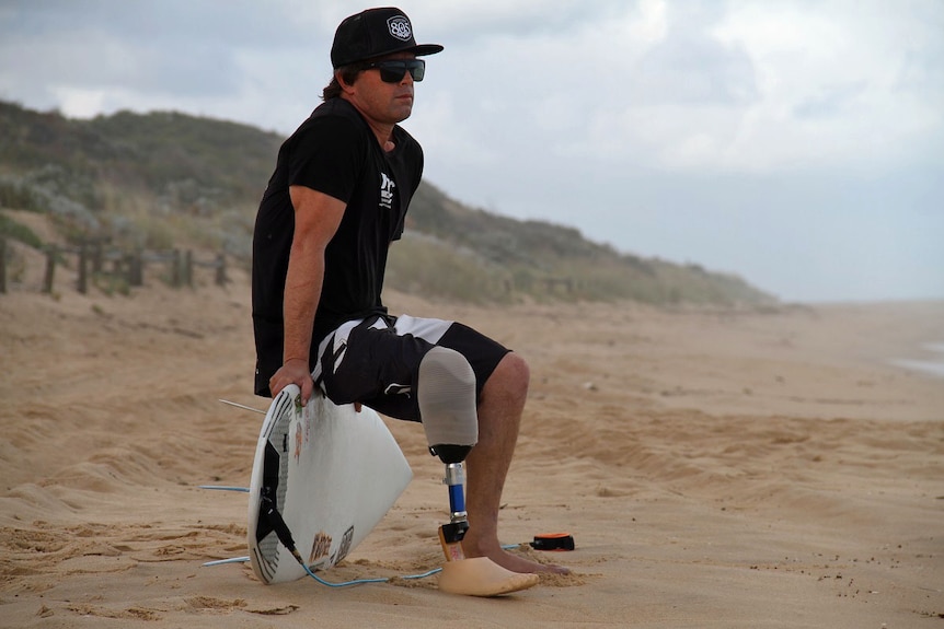 Wayne Figliomeni sitting on his board at Binningup Beach