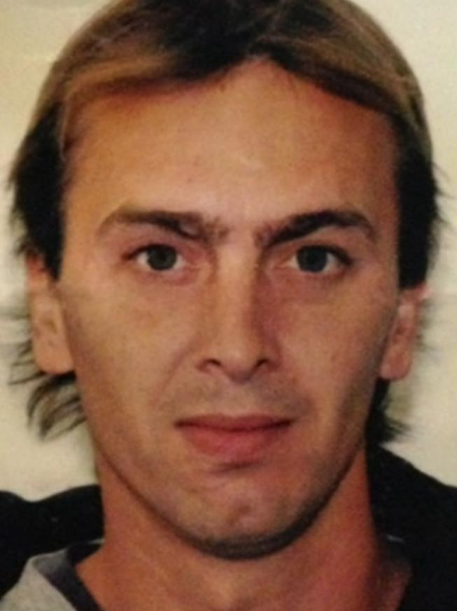 A headshot of a man with blonde hair and brown eyes.