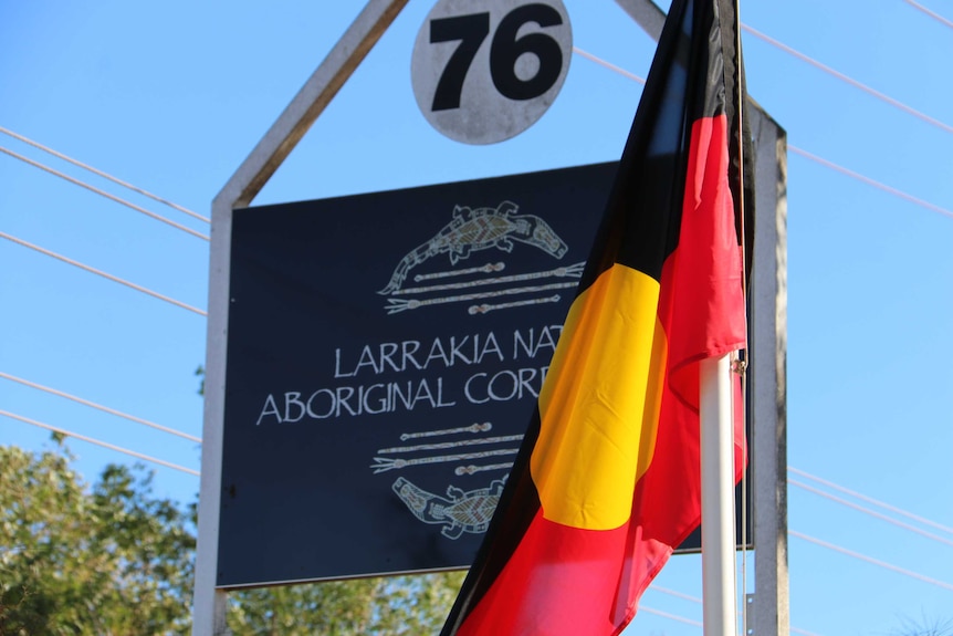 An aboriginal flag stands by the Larrakia Nation sign in Darwin.