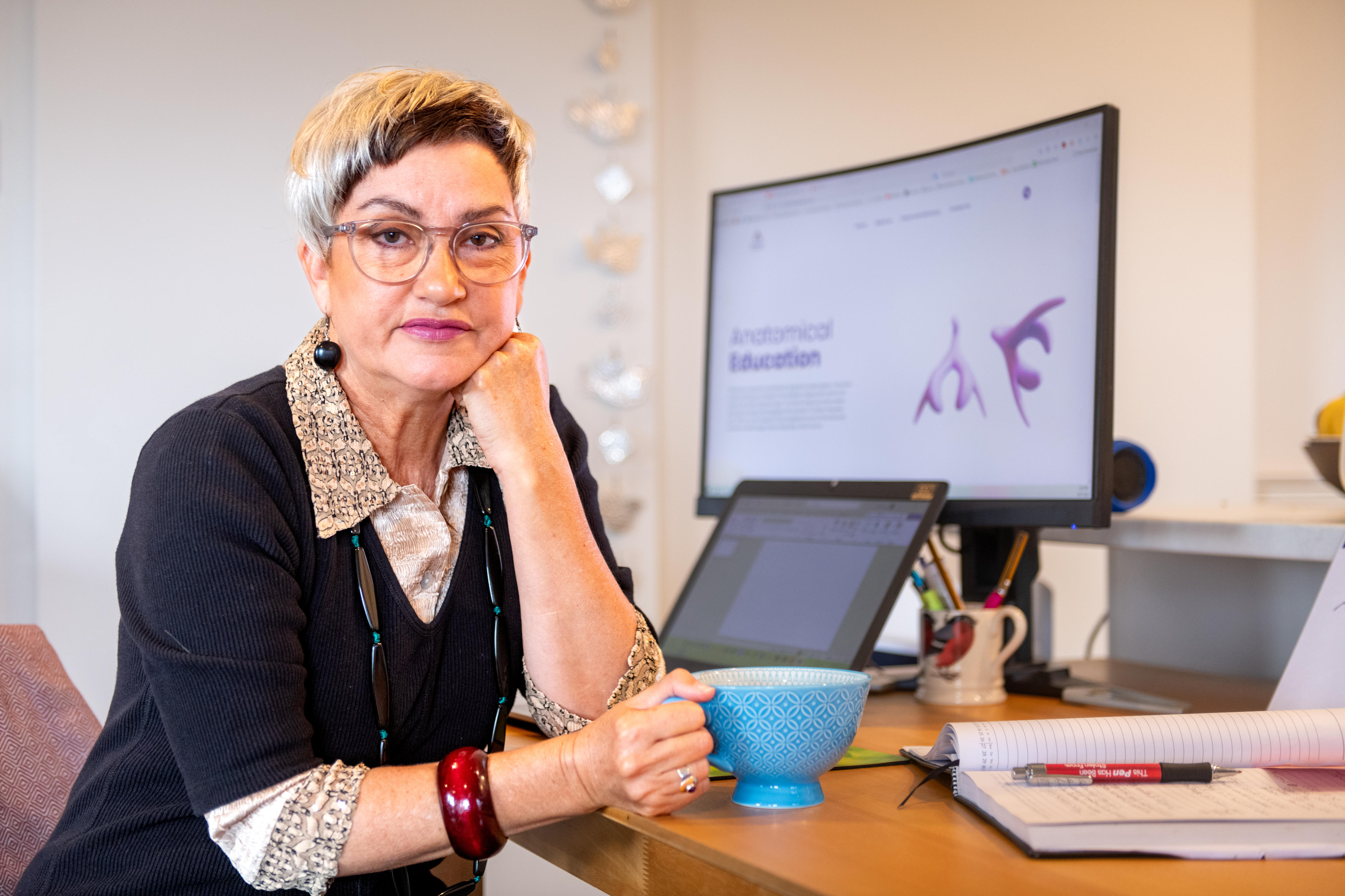 a woman sitting at a desk.