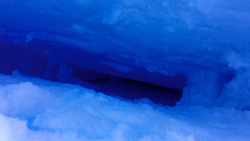 A blue, icy hole which descends into darkness.