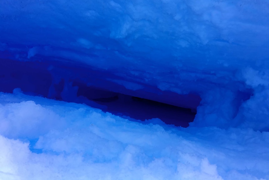 A blue, icy hole which descends into darkness.