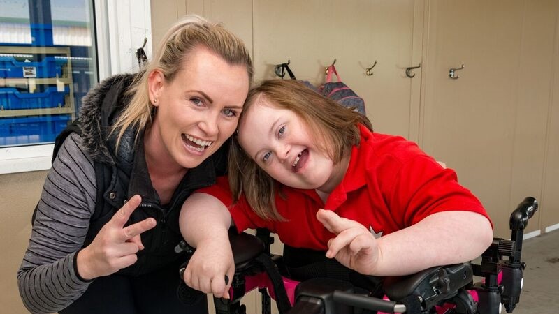 Teenager Katinka Pettet poses with her physiotherapist Heather Richmond in her new walker