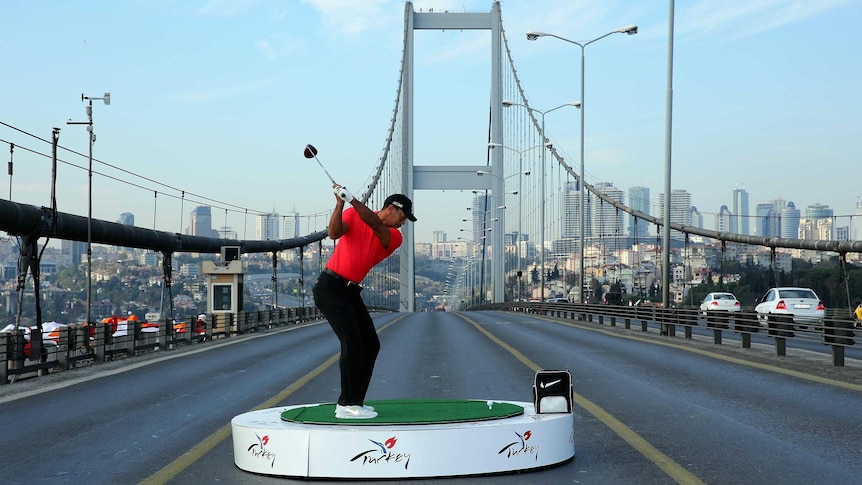 Tiger Woods hits golf balls from Asia to Europe.