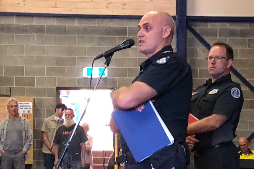 Senior Sergeant Ron Findlay of Victoria Police addressing a public meeting in Mallacoota.