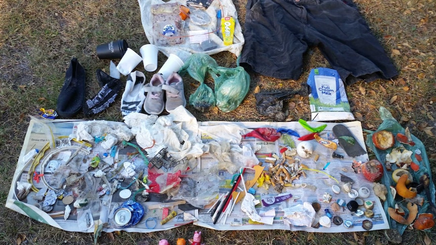 Various rubbish laid out on the grass.