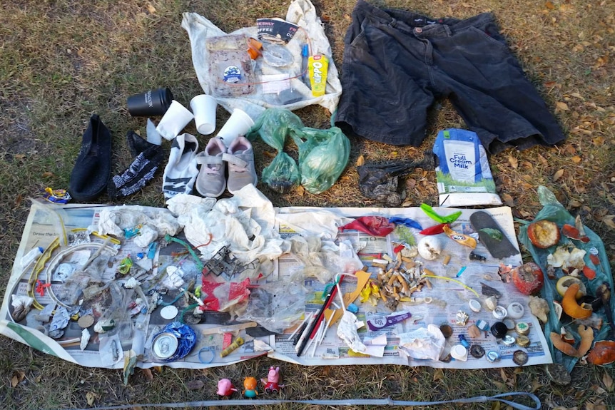 Various rubbish laid out on the grass.