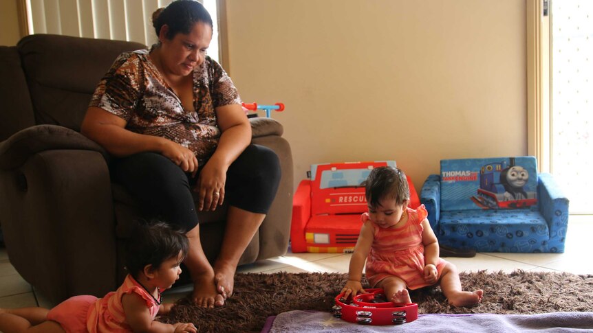 Megan Naden watches her twin baby girls play at the Gomeroi gaaynggal centre in Tamworth.