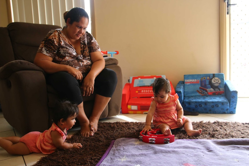 Megan Naden watches her twin baby girls play at the Gomeroi gaaynggal centre in Tamworth.