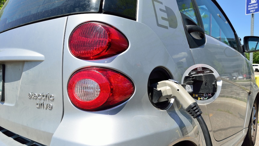 A small grey electric charge with charger nozzle attached.