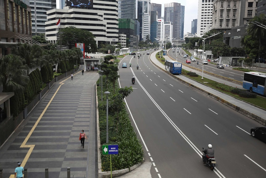 Jakarta's main Sudirman Street virtually abandoned amid the outbreak.