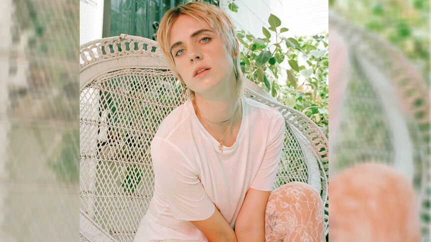 A 2017 press shot of a short-haired singer MØ sitting in a deck chair
