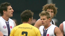 Umpire Michael Vozzo talks to Fremantle players about not hearing the final siren.